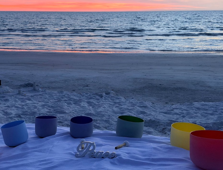 Image of singing bowls in a peaceful beach setting